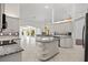 Spacious kitchen with granite countertops, an island, and a view of the outdoor pool area at 264 Rotonda N Blvd, Rotonda West, FL 33947