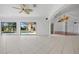 Large living room featuring tile flooring, arched doorways, and view to the pool at 264 Rotonda N Blvd, Rotonda West, FL 33947