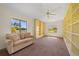 Inviting living room with carpeted floors, built-in bookshelves, and large windows for natural light at 264 Rotonda N Blvd, Rotonda West, FL 33947