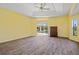 Large main bedroom with a tray ceiling, ceiling fan, and sliding glass doors that lead to the pool at 264 Rotonda N Blvd, Rotonda West, FL 33947