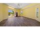 Spacious main bedroom featuring a ceiling fan and sliding glass doors that lead to the pool area at 264 Rotonda N Blvd, Rotonda West, FL 33947