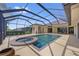 The screened-in pool area features a spa, lounge area, and private backyard oasis perfect for relaxation and entertaining at 264 Rotonda N Blvd, Rotonda West, FL 33947