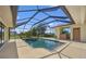 Enclosed pool area features a sparkling pool, integrated spa, and covered outdoor area at 264 Rotonda N Blvd, Rotonda West, FL 33947