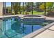 Clear swimming pool with built-in spa, surrounded by a screened enclosure and lush landscaping at 264 Rotonda N Blvd, Rotonda West, FL 33947