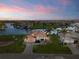 Aerial view of waterfront property with manicured lawn and a serene canal at 3322 Sandpiper Dr, Punta Gorda, FL 33950