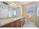 Bathroom features granite counters, wood cabinets and a glass-enclosed shower at 3322 Sandpiper Dr, Punta Gorda, FL 33950