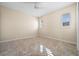 Neutral bedroom features a ceiling fan, tile floors and windows with white shutters at 3322 Sandpiper Dr, Punta Gorda, FL 33950