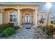 Charming front entrance with columns and beautiful landscaping at 3322 Sandpiper Dr, Punta Gorda, FL 33950