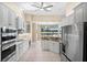 Well-lit kitchen with stainless steel appliances, white cabinets, and a breakfast bar overlooking the lake at 3322 Sandpiper Dr, Punta Gorda, FL 33950