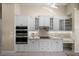 Elegant kitchen featuring built-in oven, custom cabinets, and granite countertops at 3322 Sandpiper Dr, Punta Gorda, FL 33950