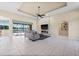 Bright living room with tile floors, ceiling fan, and fireplace at 3322 Sandpiper Dr, Punta Gorda, FL 33950