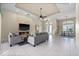 Spacious living room with a fireplace, tile floors, tray ceiling, and open floor plan at 3322 Sandpiper Dr, Punta Gorda, FL 33950