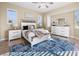 Bright main bedroom with white furniture, large windows, and a patterned blue rug at 3322 Sandpiper Dr, Punta Gorda, FL 33950