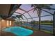 Screened pool with clear blue water and views of the waterfront canal at 3322 Sandpiper Dr, Punta Gorda, FL 33950