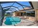 Screened lanai with kidney-shaped pool and brick patio, exterior view at 3322 Sandpiper Dr, Punta Gorda, FL 33950