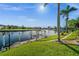 Scenic waterfront view with lush landscaping and a private boat dock at 3322 Sandpiper Dr, Punta Gorda, FL 33950