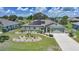 Aerial view of a well-maintained home with solar panels, lush landscaping, and a welcoming driveway at 37 Pepe Ct, Punta Gorda, FL 33983