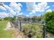 A fenced garden next to a screened-in pool offers ample space for outdoor living and gardening at 37 Pepe Ct, Punta Gorda, FL 33983