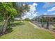The property showcases a vast yard with a view of the screened-in pool and serene green space at 37 Pepe Ct, Punta Gorda, FL 33983