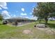 Expansive backyard with a screened-in pool, a charming bench, and lush green grass at 37 Pepe Ct, Punta Gorda, FL 33983