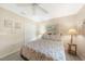 Comfortable bedroom featuring a patterned bedspread, light gray walls, and a ceiling fan at 37 Pepe Ct, Punta Gorda, FL 33983