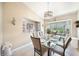 Well-lit dining area with a glass-top table, comfortable seating, and a view of the outdoors at 37 Pepe Ct, Punta Gorda, FL 33983