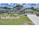 Charming one-story home with a well-manicured lawn, solar panels, and a cozy, welcoming entrance at 37 Pepe Ct, Punta Gorda, FL 33983