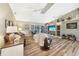 Spacious living room boasts wood-look floors, ceiling fans, and built-in shelving and fireplace at 37 Pepe Ct, Punta Gorda, FL 33983
