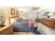 Comfortable primary bedroom with ceiling fan, dresser and view of an entertainment center at 37 Pepe Ct, Punta Gorda, FL 33983