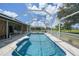 Screened-in pool area with comfortable seating, landscaping, and bright blue water at 37 Pepe Ct, Punta Gorda, FL 33983