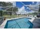 A beautiful screened-in pool features clear blue water and plenty of space for outdoor entertaining at 37 Pepe Ct, Punta Gorda, FL 33983