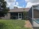 Spacious backyard featuring a screened lanai and pool, perfect for outdoor enjoyment and relaxation at 4823 Foxhall Rd, North Port, FL 34288