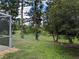 Expansive backyard with lush greenery and mature trees, providing privacy and a natural setting at 4823 Foxhall Rd, North Port, FL 34288