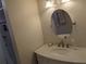 Bathroom featuring a decorative vanity with oval mirror and overhead lighting at 4823 Foxhall Rd, North Port, FL 34288