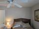 Bedroom with natural light, ceiling fan and door to hallway at 4823 Foxhall Rd, North Port, FL 34288