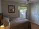 Bedroom with natural light, ceiling fan and door to hallway at 4823 Foxhall Rd, North Port, FL 34288