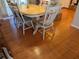 Wood-floored dining room with white wooden table and chairs at 4823 Foxhall Rd, North Port, FL 34288