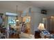 An open-plan dining room with an open design leading into a kitchen area, and light fixtures at 4823 Foxhall Rd, North Port, FL 34288