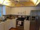 Functional kitchen with stainless steel appliances, bright white cabinets, and ample counter space at 4823 Foxhall Rd, North Port, FL 34288