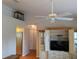 Interior shot showcasing a white ceiling fan and entertainment center, with natural light through the window at 4823 Foxhall Rd, North Port, FL 34288