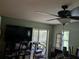 Cozy living room with ceiling fan and glass sliding doors leading to outdoor view at 4823 Foxhall Rd, North Port, FL 34288