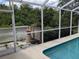 Enclosed pool area with outdoor living space, perfect for entertaining and relaxation at 4823 Foxhall Rd, North Port, FL 34288