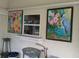Charming screened porch featuring colorful artwork and views of the outdoors at 4823 Foxhall Rd, North Port, FL 34288