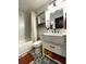 A remodeled bathroom features a vanity, toilet, and a shower with a marble-like tile surround at 4854 Flamlau Ave, North Port, FL 34287