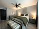 A bedroom with an accent wall, a queen bed, ceiling fan, and modern decorations at 4854 Flamlau Ave, North Port, FL 34287