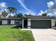 Charming single-story home featuring a well-maintained lawn and a two-car garage at 4854 Flamlau Ave, North Port, FL 34287