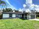 Charming single-story home with well-maintained lawn and attached garage at 4854 Flamlau Ave, North Port, FL 34287
