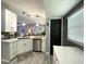 A recently remodeled kitchen showcases white cabinets and stainless steel appliances at 4854 Flamlau Ave, North Port, FL 34287