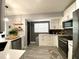 Modern kitchen featuring white cabinets, stainless steel appliances, and a functional layout at 4854 Flamlau Ave, North Port, FL 34287
