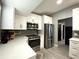A modern kitchen features stainless steel appliances, white cabinets, and tile backsplash at 4854 Flamlau Ave, North Port, FL 34287